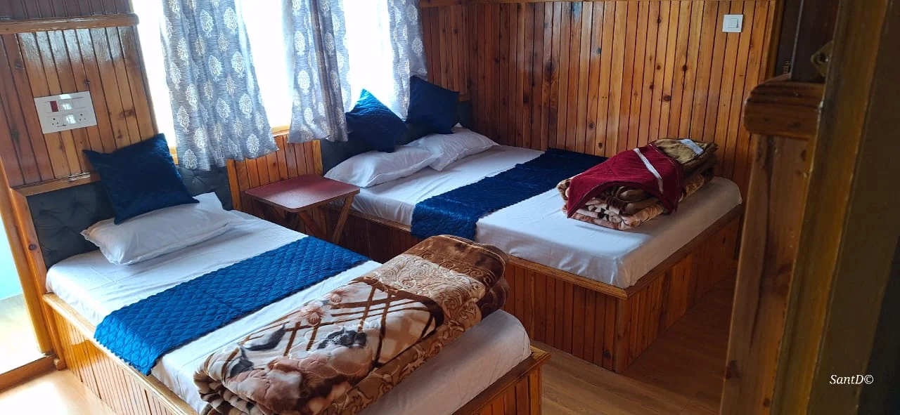 Kolakham Nature View Home Stay - Deluxe Triple Room Interior with Pine Paneling