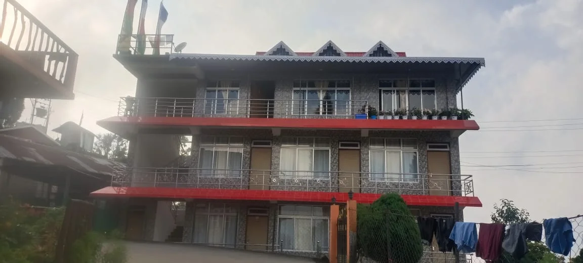 Rishabh Rich Homestay - Daytime 3-Story Cottage Facade with Balconies